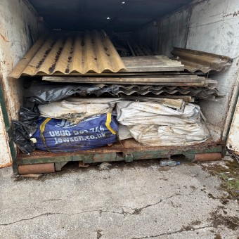 Abandoned skip with roof asbestos inside