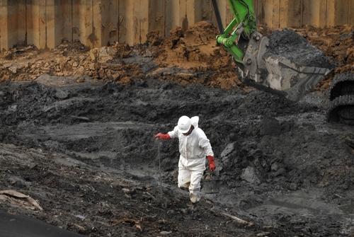 showing man testing contaminated soil